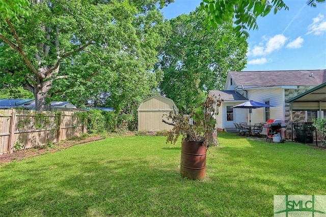 219 N College St, Pembroke, GA 31321 - view of yard featuring a storage shed, fence, and an outbuilding