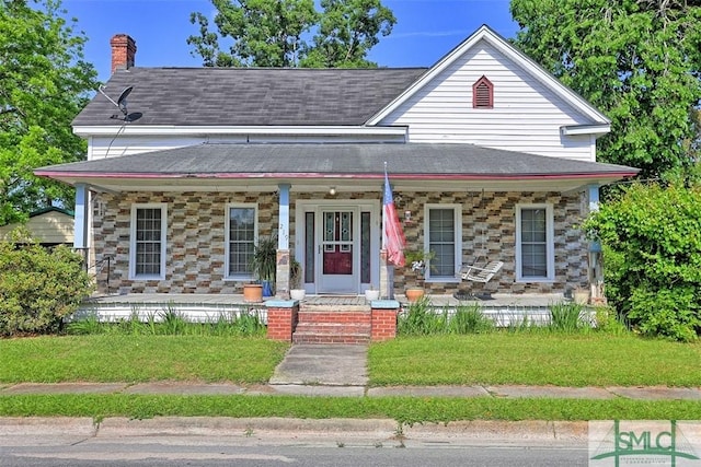 219 N College St, Pembroke, GA 31321 - view of front of house featuring a shingled roof, covered porch, and a chimney