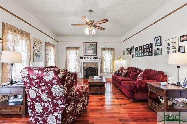 219 N College St, Pembroke, GA 31321 - living room with a brick fireplace, ceiling fan, crown molding, and wood finished floors