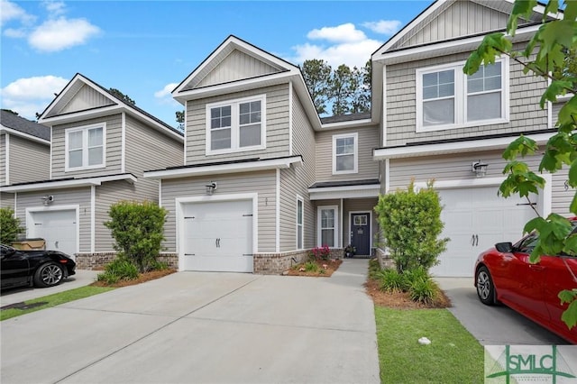 view of front facade with board and batten siding, an attached garage, and driveway