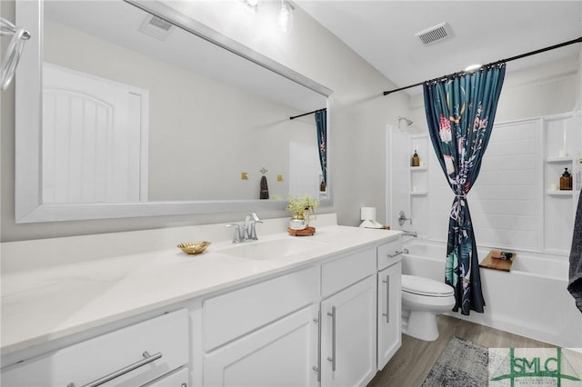 bathroom featuring visible vents, wood finished floors, vanity, toilet, and shower / tub combo with curtain