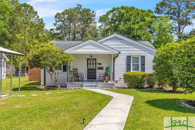 bungalow-style house featuring covered porch and a front lawn