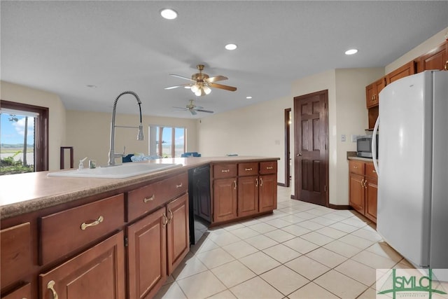 1443 Gillican Ave NE, Townsend, GA 31331 - kitchen featuring freestanding refrigerator, a sink, stainless steel microwave, a ceiling fan, and dishwasher