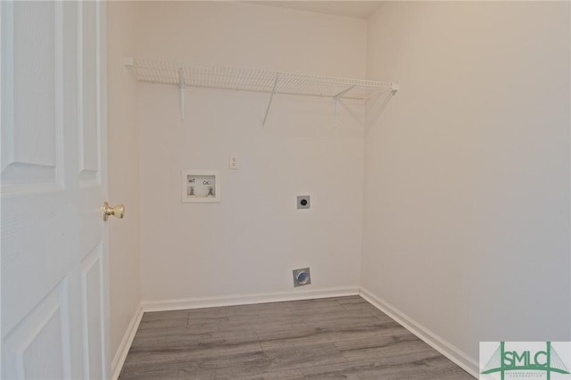 clothes washing area featuring laundry area, electric dryer hookup, wood finished floors, baseboards, and hookup for a washing machine