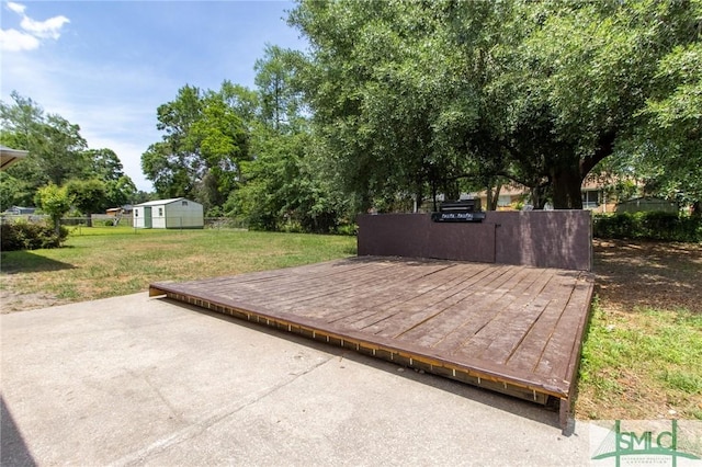 deck featuring a lawn and fence