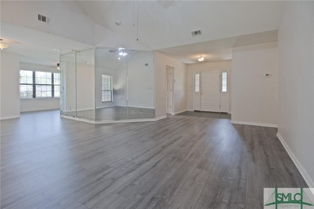 interior space featuring baseboards, visible vents, and dark wood finished floors