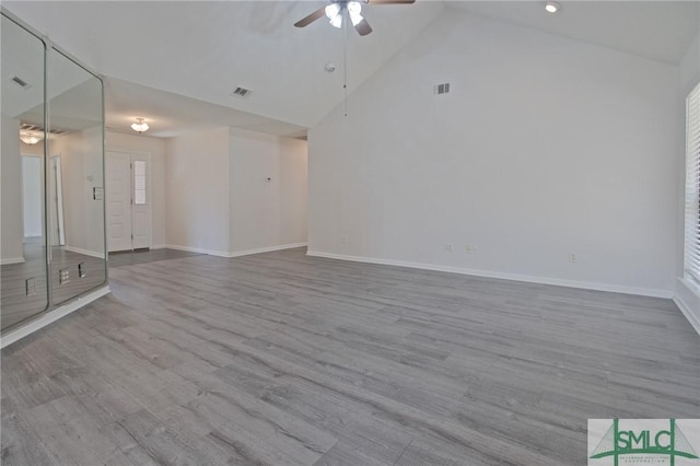 unfurnished living room with baseboards, a ceiling fan, and wood finished floors