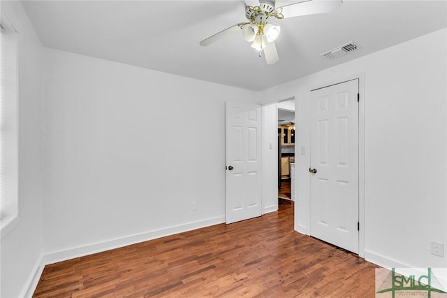 819 W 51st St, Savannah, GA 31405 - unfurnished bedroom with wood finished floors, baseboards, and a ceiling fan
