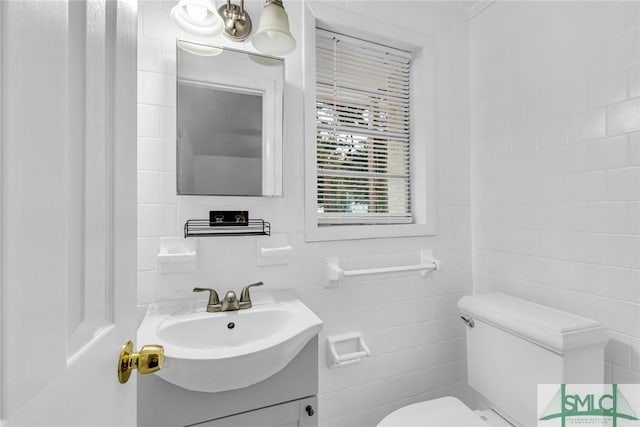 819 W 51st St, Savannah, GA 31405 - bathroom with tile walls, toilet, and vanity