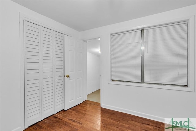 819 W 51st St, Savannah, GA 31405 - unfurnished bedroom with wood finished floors, baseboards, and a closet