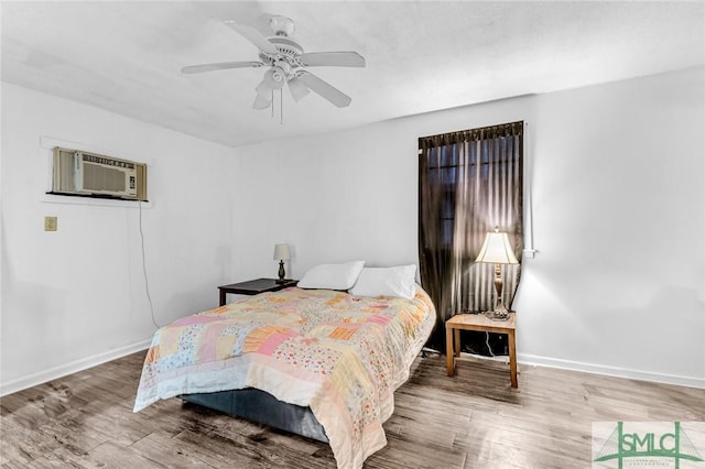 819 W 51st St, Savannah, GA 31405 - bedroom featuring wood finished floors, baseboards, ceiling fan, and a wall mounted air conditioner