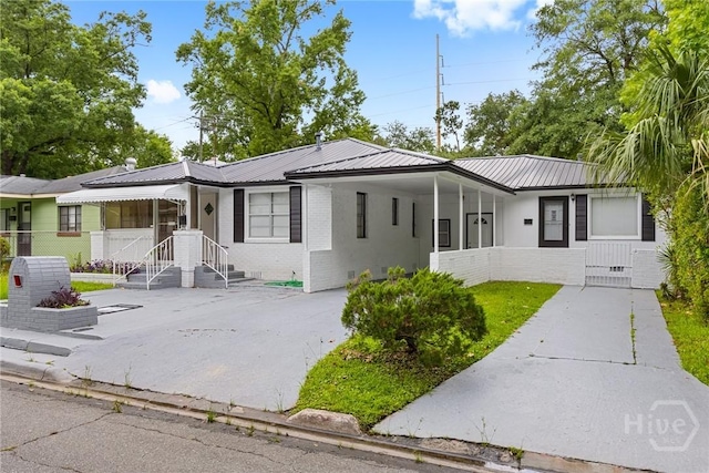 819 W 51st St, Savannah, GA 31405 - view of front of house featuring concrete driveway, brick siding, metal roof, an attached carport, and crawl space
