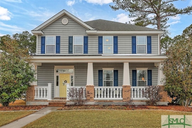 view of front of property with a front lawn and covered porch