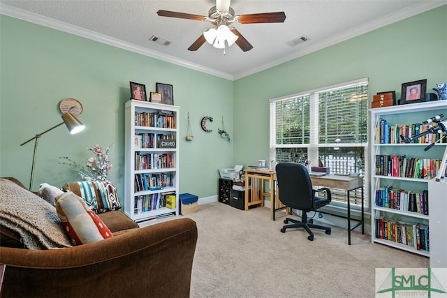 carpeted office space with ceiling fan, visible vents, ornamental molding, and baseboards