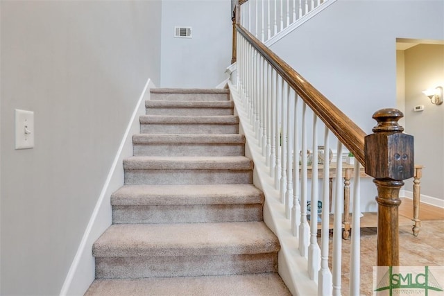 stairs featuring baseboards and visible vents