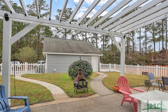 view of patio / terrace featuring a pergola, fence, and an outbuilding