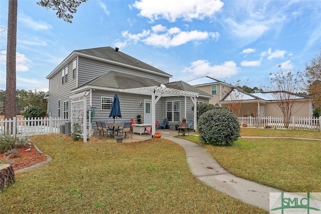 rear view of property with a yard, a pergola, fence, and a patio area