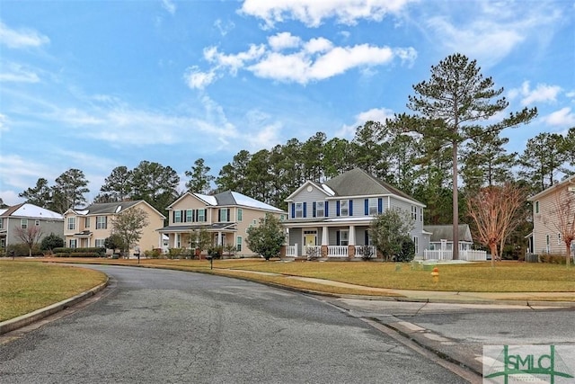 view of front of home with a residential view and a front lawn
