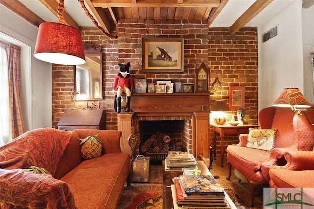 sitting room featuring visible vents, wooden ceiling, a fireplace, beamed ceiling, and brick wall