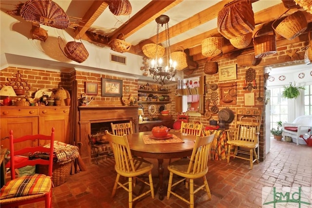 dining room with a notable chandelier, brick floor, brick wall, visible vents, and beamed ceiling