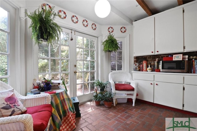 sunroom with beamed ceiling and french doors