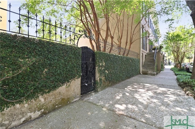 view of gate featuring stairway