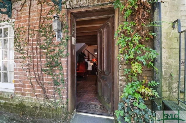 view of exterior entry featuring brick siding