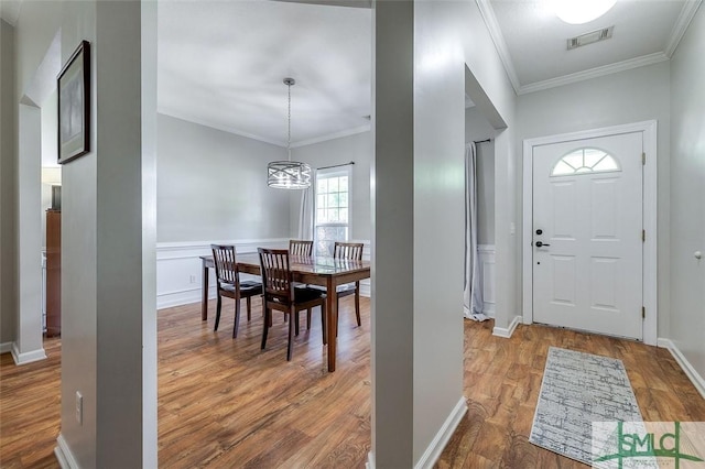 213 Rosehill Dr E, Rincon, GA 31326 - foyer entrance with visible vents, wood finished floors, ornamental molding, and a notable chandelier