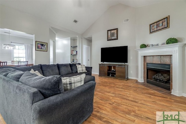 213 Rosehill Dr E, Rincon, GA 31326 - living area with a fireplace, light wood-style flooring, high vaulted ceiling, and visible vents