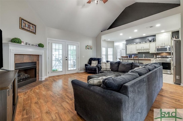 213 Rosehill Dr E, Rincon, GA 31326 - living area featuring french doors, light wood-type flooring, visible vents, ceiling fan, and a tile fireplace