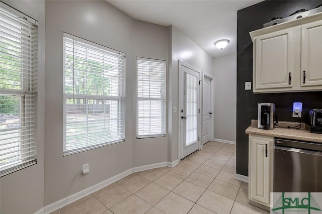 213 Rosehill Dr E, Rincon, GA 31326 - kitchen with dishwasher, white cabinetry, light countertops, light tile patterned floors, and baseboards