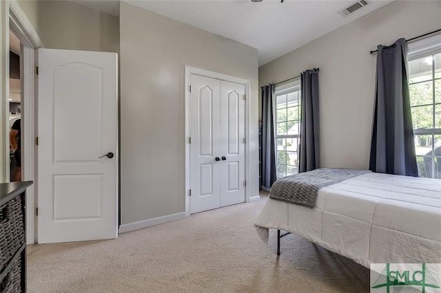 213 Rosehill Dr E, Rincon, GA 31326 - carpeted bedroom featuring baseboards, multiple windows, a closet, and visible vents