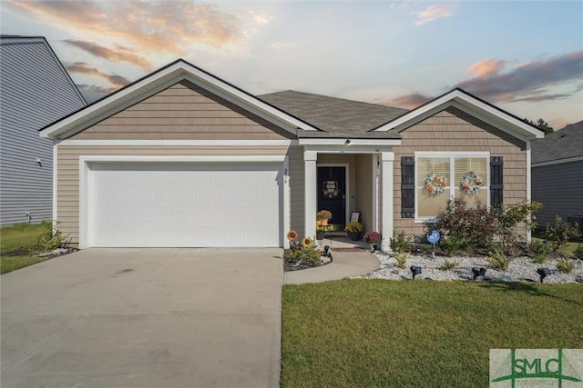 view of front of home with an attached garage, driveway, and a front yard