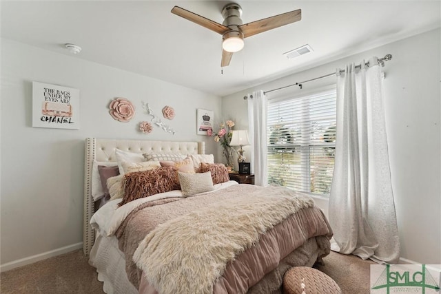 carpeted bedroom with visible vents, baseboards, and ceiling fan