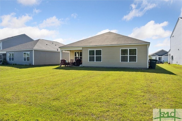 rear view of property with a lawn