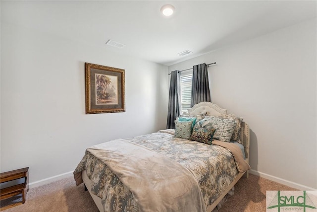 bedroom featuring baseboards, carpet flooring, and visible vents