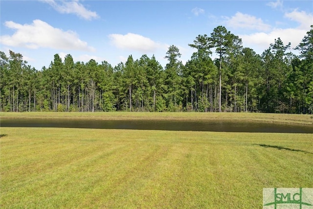 view of yard with a view of trees