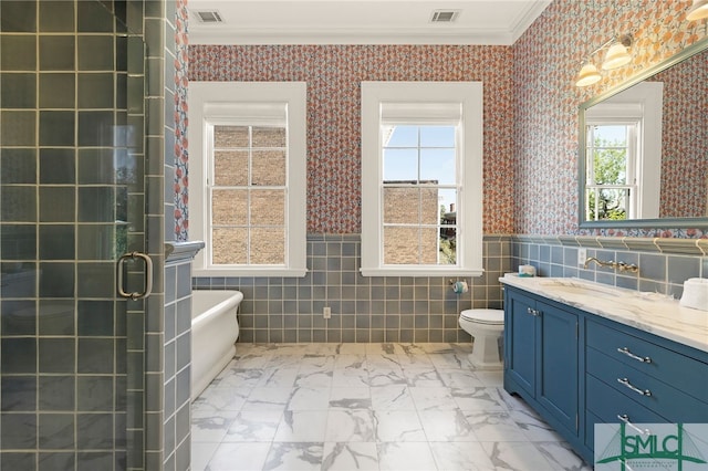 bathroom with marble finish floor, tile walls, crown molding, and visible vents