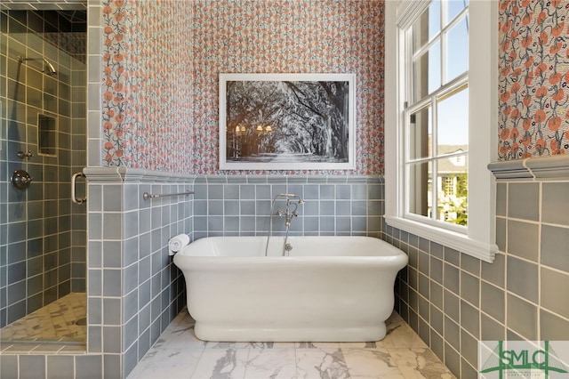 bathroom featuring a stall shower, a soaking tub, and wallpapered walls