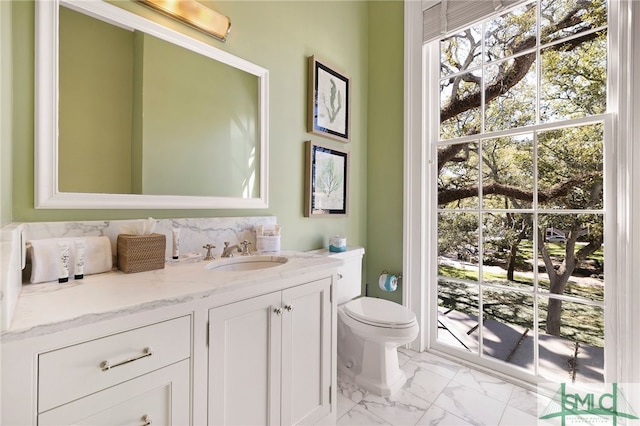 bathroom featuring vanity, toilet, and marble finish floor