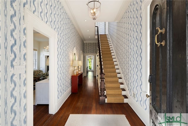 entrance foyer with baseboards, ornamental molding, wood-type flooring, and wallpapered walls