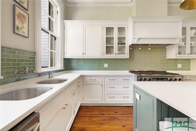 kitchen with tasteful backsplash, stainless steel gas cooktop, dishwasher, light countertops, and white cabinets