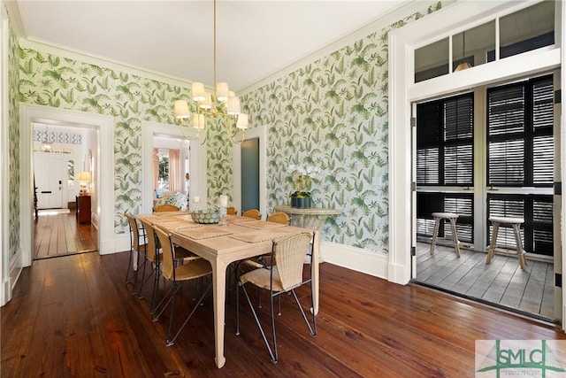 dining room with wallpapered walls, an inviting chandelier, ornamental molding, and dark wood-style floors