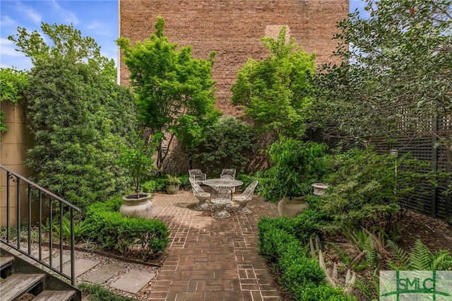 view of yard featuring a patio area and outdoor dining area