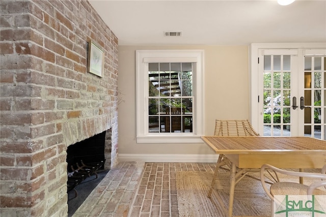 interior space featuring plenty of natural light, visible vents, and french doors