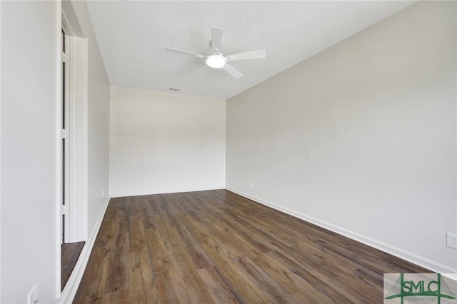 unfurnished room with a ceiling fan, baseboards, and wood finished floors