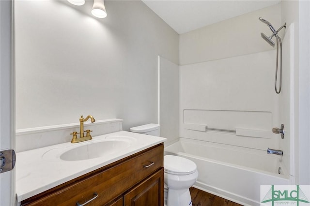 bathroom featuring toilet, shower / bathing tub combination, wood finished floors, and vanity