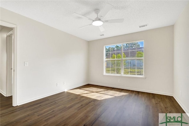 empty room featuring wood finished floors, a textured ceiling, visible vents, a ceiling fan, and baseboards