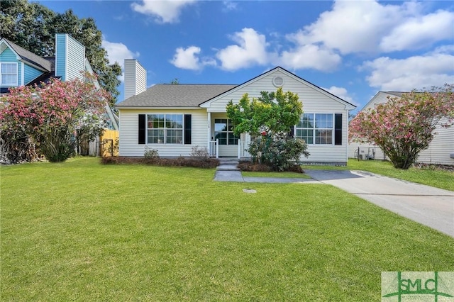 single story home with a front lawn, a chimney, and fence
