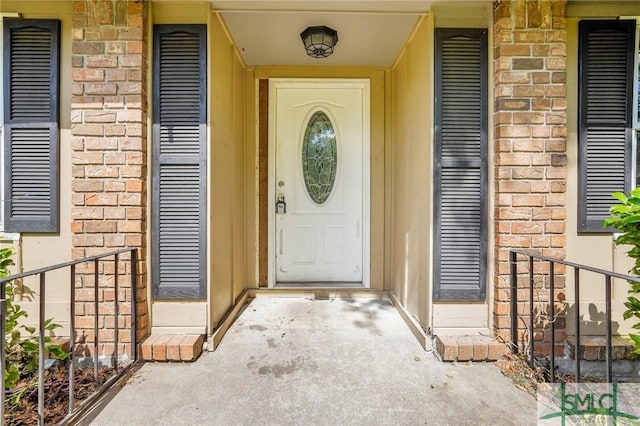 property entrance with brick siding